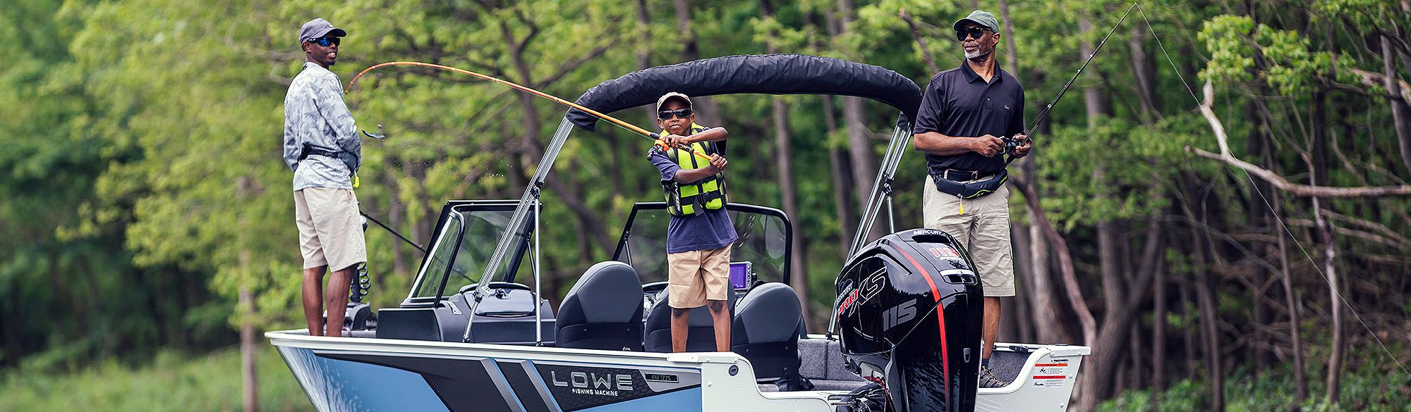 Father and son standing up, fishing on Lowe FM 1775, Starboard view