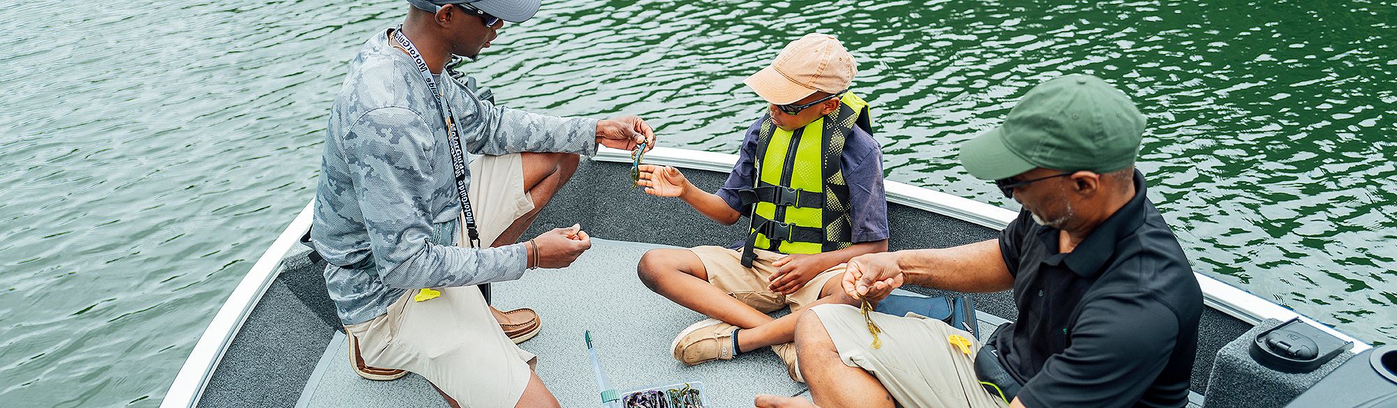 Man tying a knot on a Lowe fishing boat.